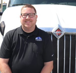 Man in front of International truck